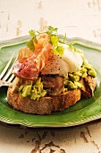 Bread topped with avocado, mushrooms, bacon and a poached egg