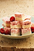 Cubes of coconut and raspberry ice cream with fresh raspberries