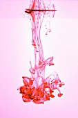 Red ink dripping into water