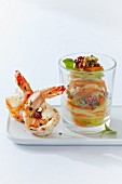 Colourful vegetable spaghetti made from kohlrabi, carrots, radish and cucumber, with fried king prawns
