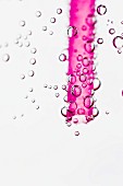 Pink drinking straw in water