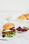A burger with Brie, bacon and cherry sauce