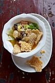 Crispy rice with vegetarian sausage, dumplings, mushrooms, bamboo and vegetables