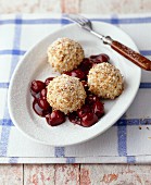 Quark dumplings with grated coconut and stewed cherries