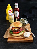 Hamburger with bacon, mayonnaise and pickled gherkins