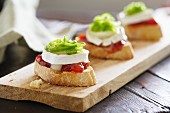 Toast topped with tomato chutney, goat's cheese and confit of green peppers
