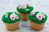 Vanilla cupcakes with buttercream and sweet Easter-themed decorations