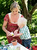 Mother and son planting seed, Stockholm, Sweden