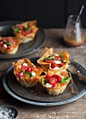 Filo pastry tartlets with caprese (tomatoes, basil and mozzarella)