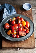 Assorted varieties of tomato on a pewter plate