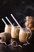 Smoothies made from nectarines, bananas and vanilla yoghurt, in three glasses with straws