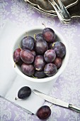 Plums in a white bowl