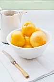 Yellow plums in a white bowl