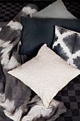 Scatter cushion with sequins, black and white cushions and batik-look blanket
