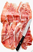 Several slices of Prosciutto from Sardinia, and a knife