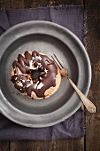 A crossover between a doughnut and a croissant, with chocolate glaze