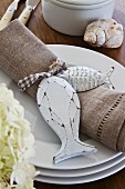 Linen napkin with accessories on stack of plates