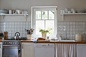Bright, simple kitchen with white units