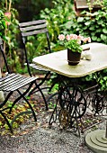 Unusual garden table made from stone table top on antique sewing machine base