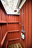 Outdoor shower with red wood panelling