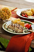 Grilled halibut with corn cobs and tomatoes