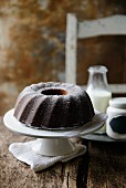 Bundt cake and a bottle of milk on a rustic wooden table