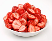 Whole and halved strawberries in a bowl