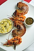 A skewer of barbecued beef and prawns, with lemon risotto