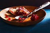 Broken up pomegranate in a wooden dish