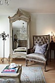 Neo-classical armchair next to antique wardrobe with mirrored door