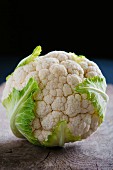 A cauliflower on a wooden surface