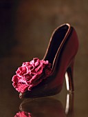 A chocolate shoe with a sugar rose