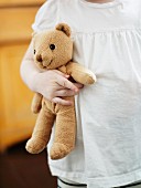 A girl holding a teddybear.