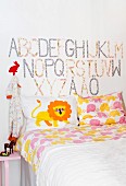 Nursery room with bed and alphabets on wall