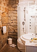 Modern shower & washstand in bathroom with stone walls in manor house (Languedoc, France)