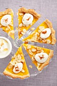 Pumpkin tart with flaked almonds, cut into slices