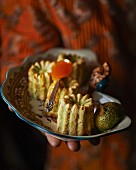 A person serving cannelés made from veal pâté