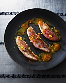 Fried red mullet with orange sauce