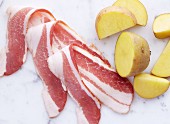 Cut Raw Potatoes and Slices of Bacon