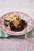 A portion of berry & plum cobbler on a plate
