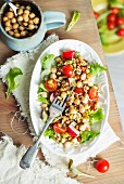 Lettuce with chickpeas, cherry tomatoes, radishes and edible shoots
