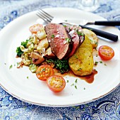 Beef steak with fried potatoes, tomatoes and mushrooms
