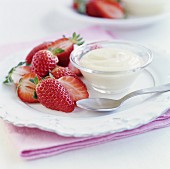 Fresh strawberries with a bowl of white chocolate sauce