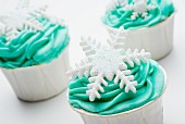 Cupcakes decorated with green icing and snowflakes