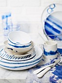 Blue and white crockery (plates, cups, bowls) and cutlery