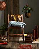 Home accessories in dark shades - wooden chair, blanket, cushion, rug