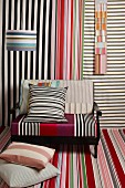 Colourful striped designs on fabric swatches, armchair and lampshade