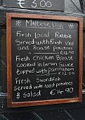A menu board with dishes from Malta