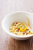 Carbonara in a White Bowl with an Egg Yolk