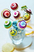 Flowers made from buttons in small vase